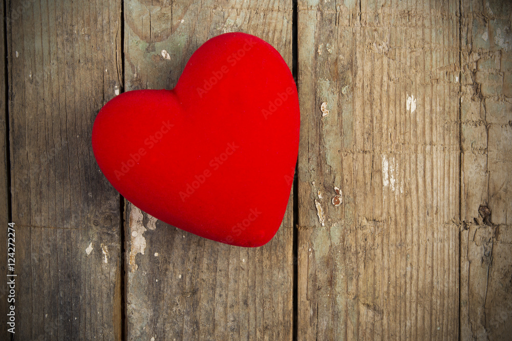 Red heart is placed on a wooden floor. Red heart is placed on a wooden floor.