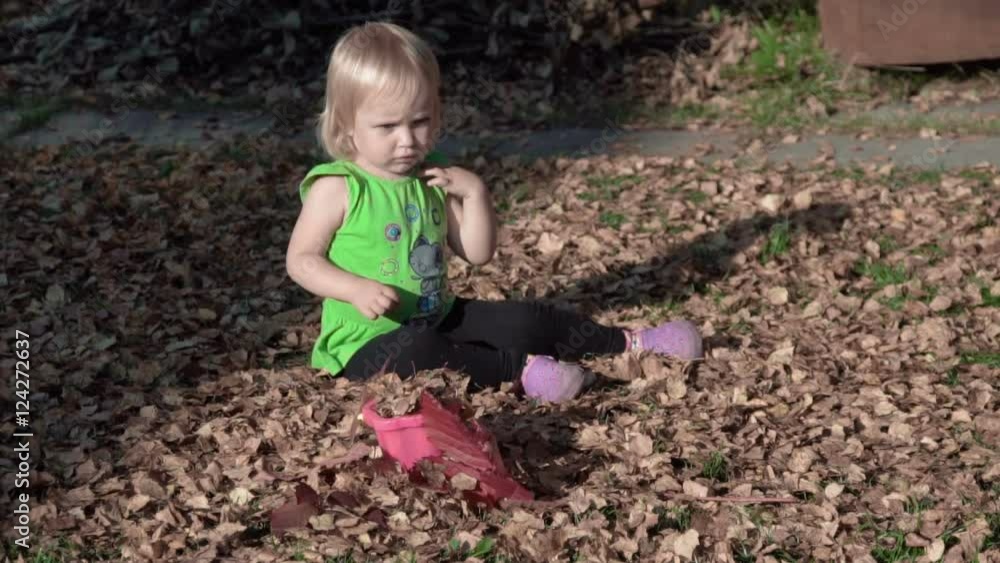 Cute baby girl playing with leaves in autumn Cute baby girl playing with leaves in autumn