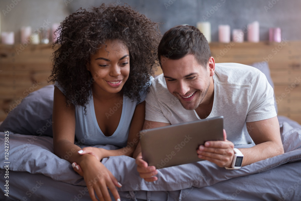 Young couple enjoying their photos on a tablet Young couple enjoying their photos on a tablet