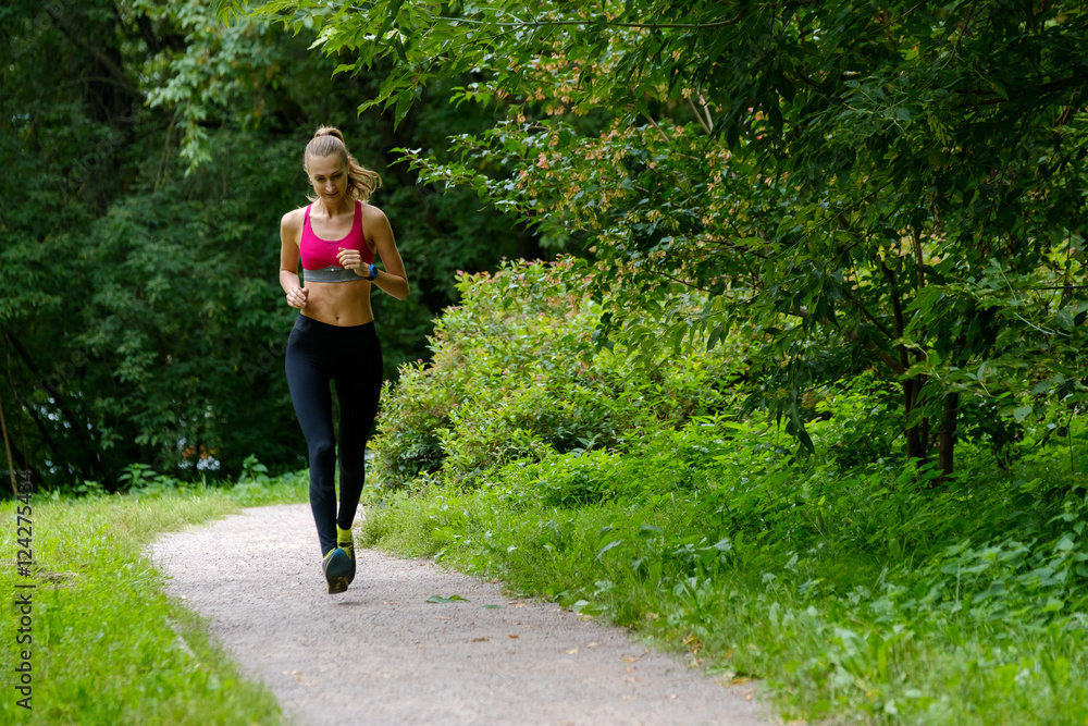 Young slim woman jogging in a park Young slim woman jogging in a park