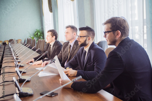 Modern managers listening to speaker at conference or seminar