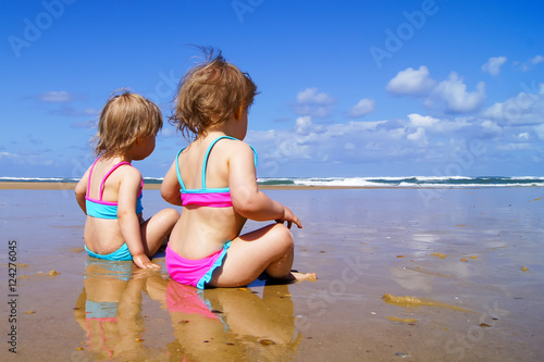 Two little girls on the beach.