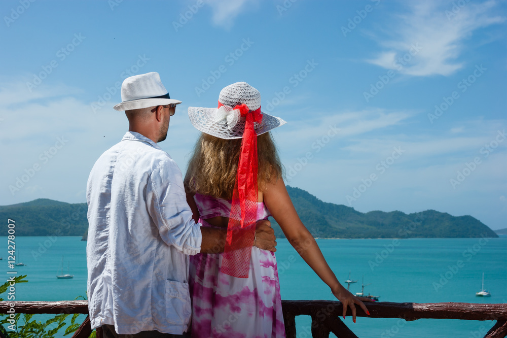 happy young couple standing on the beach ocean