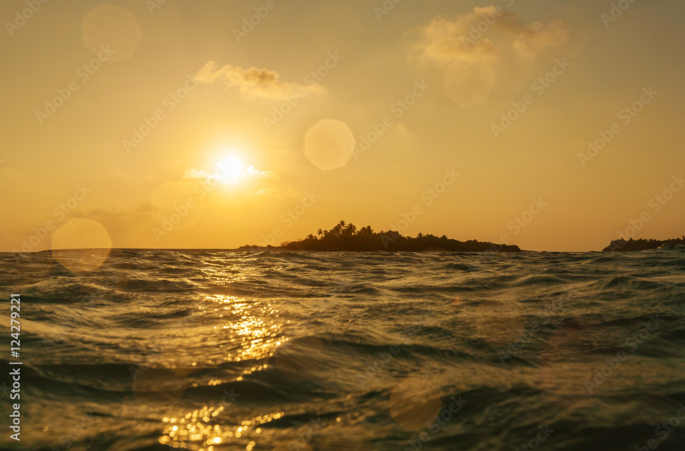 Romantic orange sunset with tropical island, Maldives