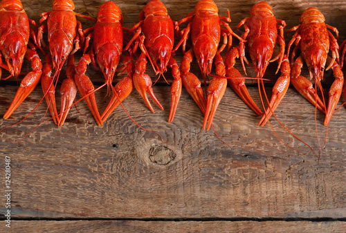 Fresh boiled crayfish with dill on a wooden background. Top view