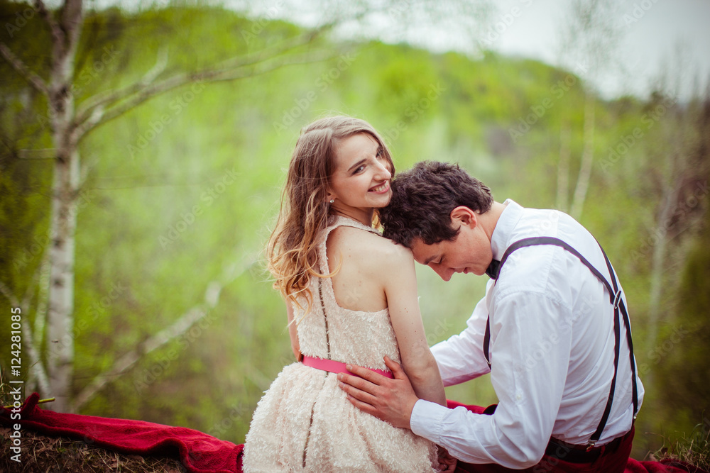 Naklejka premium Dreamy lady smiles while man lies his head on her hand