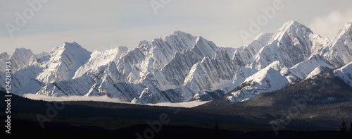 Snow covered mountain range with cloud in valley;Kananaskis alberta canada photo
