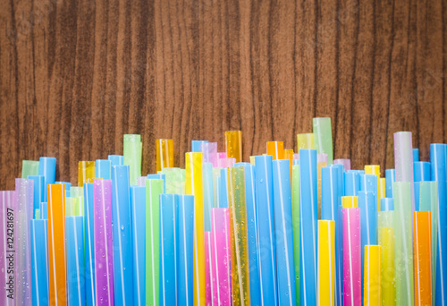 colorful striped drinking straw on wood board