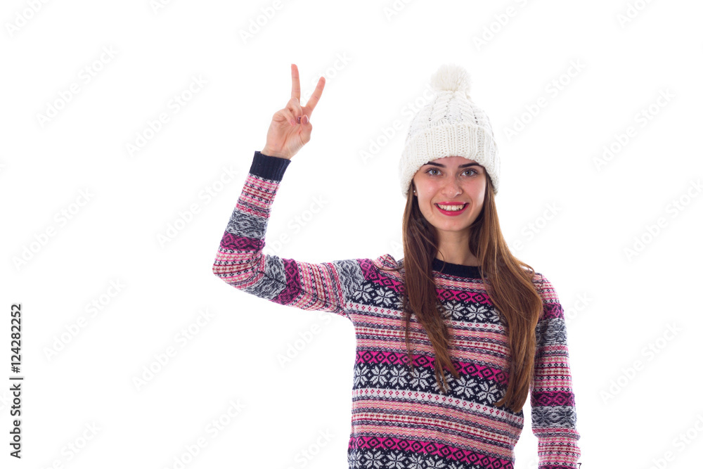 Woman in sweater and white hat showing PEACE Woman in sweater and white hat showing PEACE