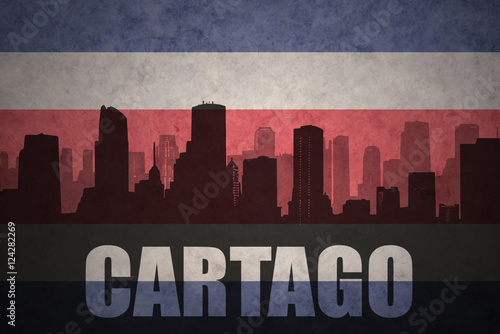 abstract silhouette of the city with text Cartago at the vintage costa rican flag