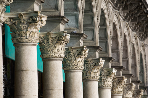 Close up of the tops of a row of corinthian columns and arches;Milano lombardia italy