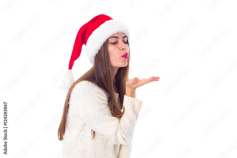 Woman in red christmas hat sending air kiss Woman in red christmas hat sending air kiss