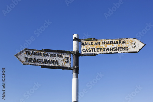 Road sign in english and gaelic pointing to castletownshend and tragumna;County cork ireland
