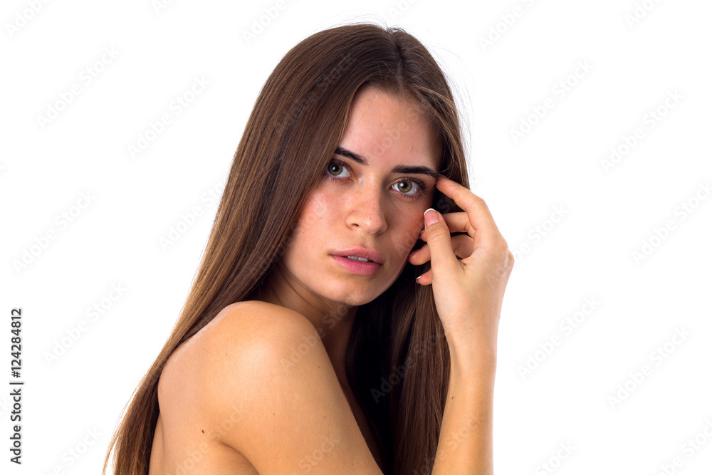 Woman standing sidewise and touching face Woman standing sidewise and touching face