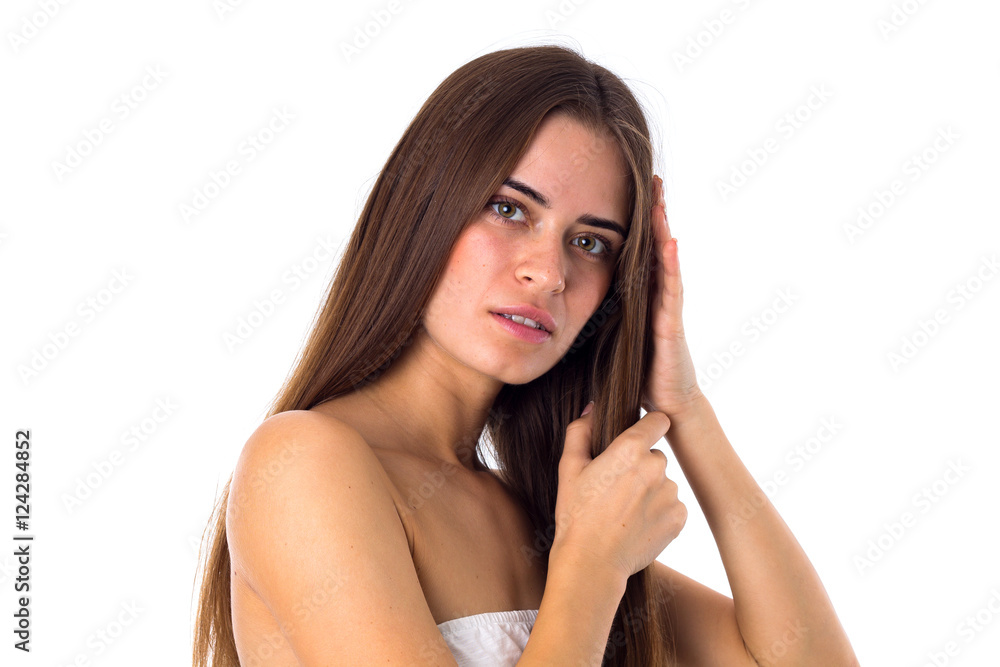 Woman standing sidewise and touching hair Woman standing sidewise and touching hair