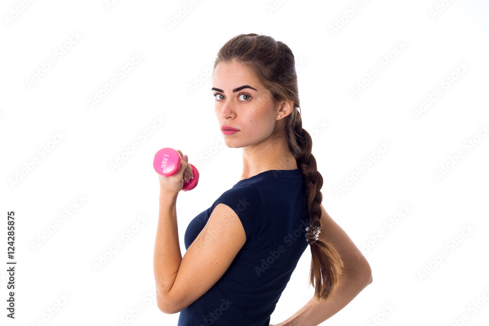 Woman holding a pink dumbbell Woman holding a pink dumbbell