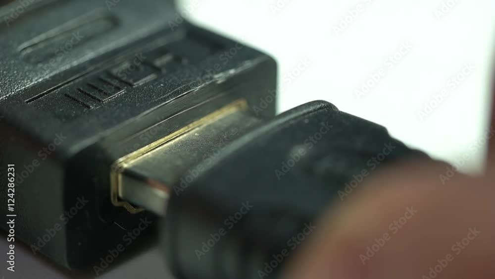 a person inserts a HDMI connector a person inserts a HDMI connector