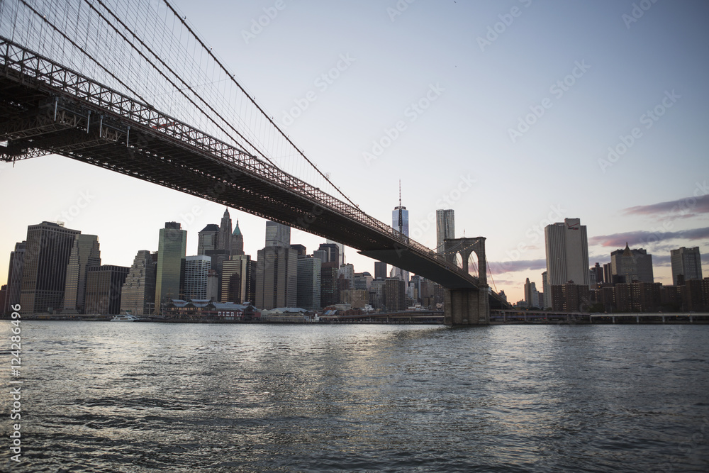 Brooklyn Bridge heading into Manhattan at dusk; New York City, New York, United States of America Brooklyn Bridge heading into Manhattan at dusk; New York City, New York, United States of America