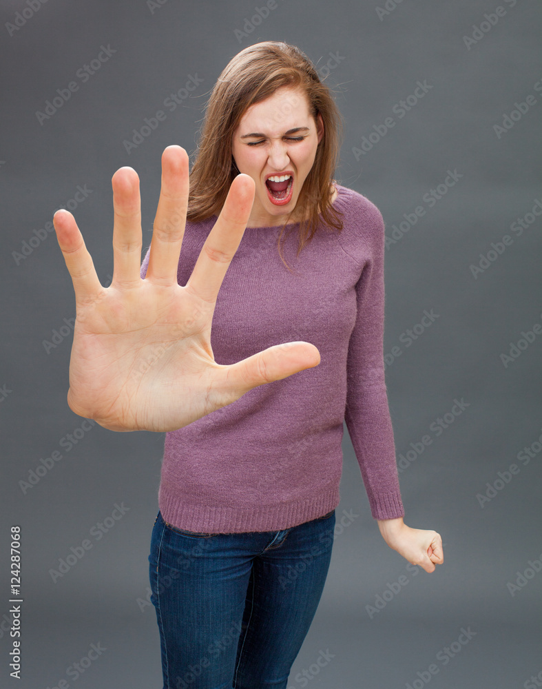 furious girl having tantrum, shouting in showing large hand forward furious girl having tantrum, shouting in showing large hand forward