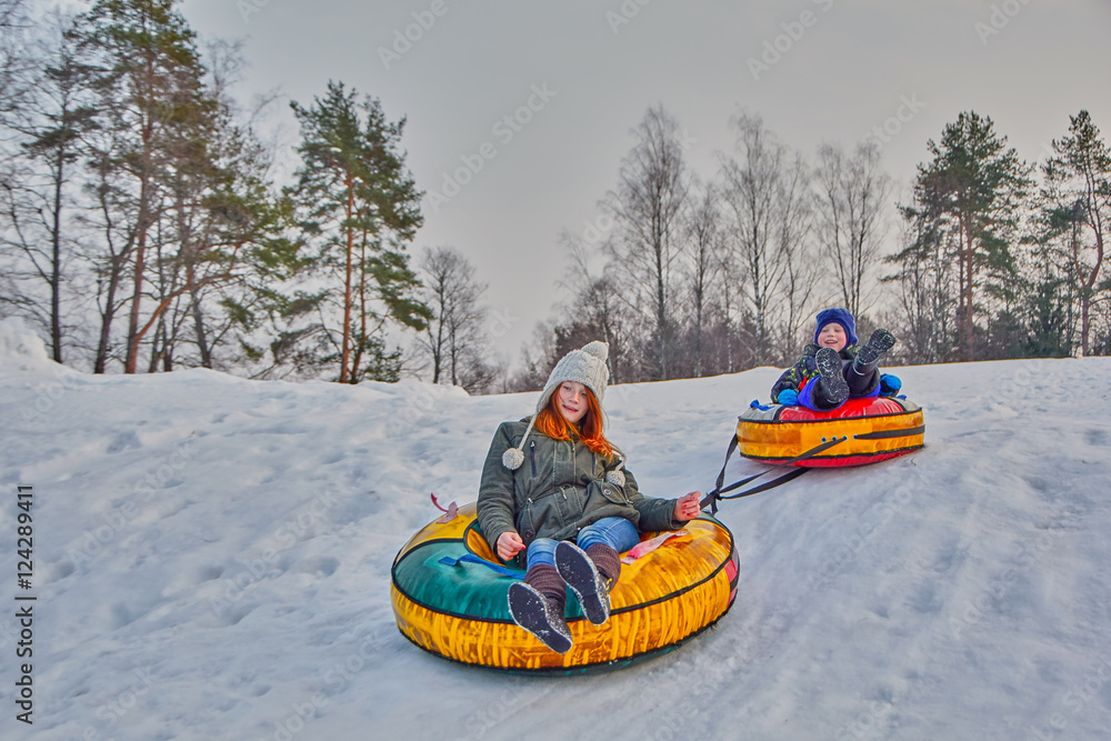 Happy children on a winter sleigh ride