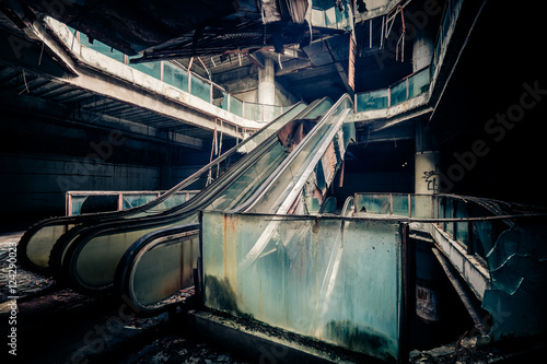 Dramatic view of damaged escalators in abandoned building. Apocalyptic and evil concept