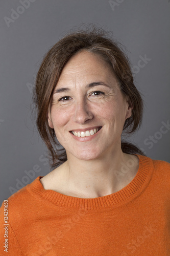 natural, beautiful middle aged woman with brown hair smiling