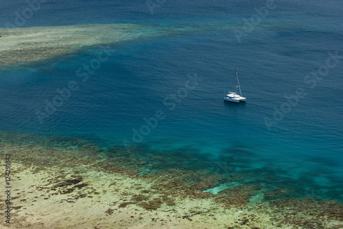 Catamaran moored off a shallow reef