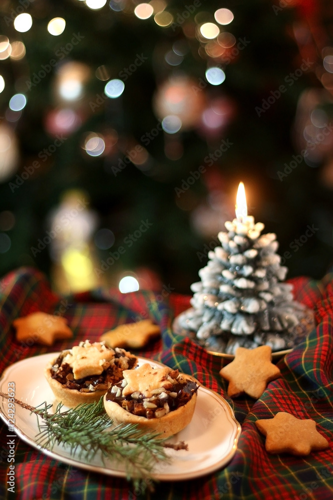 Christmas pastry filled with apples, almonds and chocolate with star shaped cookies. Selective focus and festive background. 