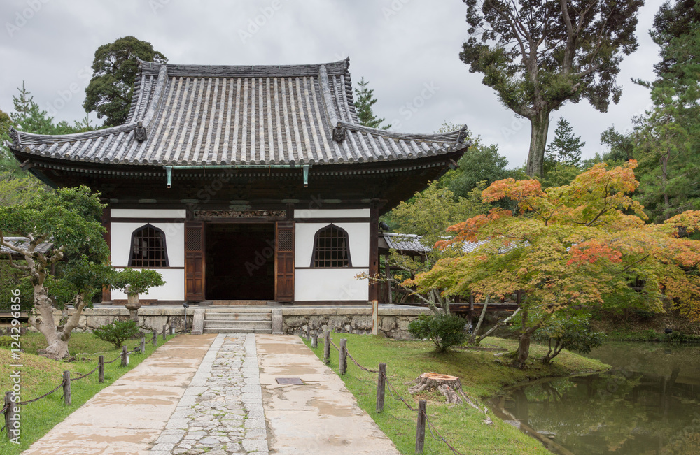 Kyoto, Japan - September 19, 2016: Smaller hall of the Kodai-ji Buddhist Temple complex sits in a beautiful garden which starts to show autumn colors. Gray sky. Kyoto, Japan - September 19, 2016: Smaller hall of the Kodai-ji Buddhist Temple complex sits in a beautiful garden which starts to show autumn colors. Gray sky.