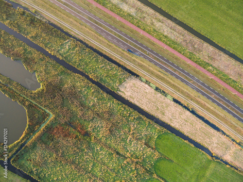 aerial view of green agricultural fields with greenhouse in Netherlands photo