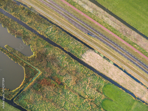 aerial view of green agricultural fields with greenhouse in Netherlands photo