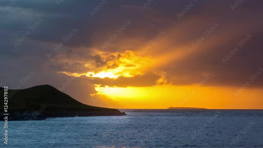 Sunset behind Flat Holm Island in the Bristol Channel. Spectacular sky and clouds seen from Sand Point, north of Weston-super-Mare in Somerset, UK Sunset behind Flat Holm Island in the Bristol Channel. Spectacular sky and clouds seen from Sand Point, north of Weston-super-Mare in Somerset, UK