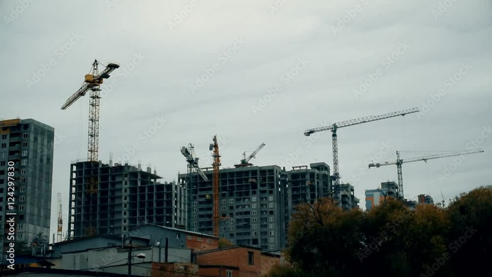 Time lapse of constuction site with many cranes building many highrise apartment blocks Time lapse of constuction site with many cranes building many highrise apartment blocks