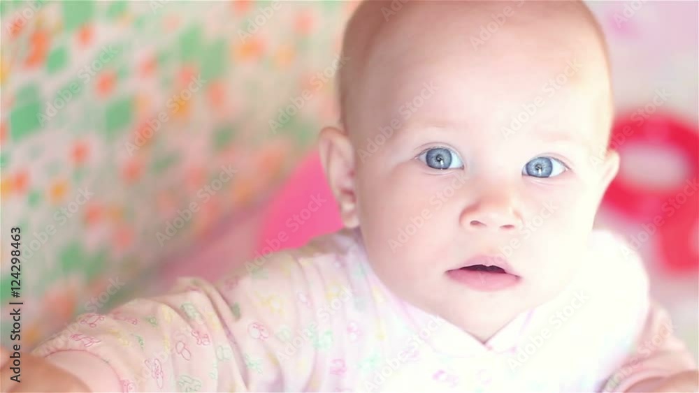happy baby in bed and looking at the camera happy baby in bed and looking at the camera