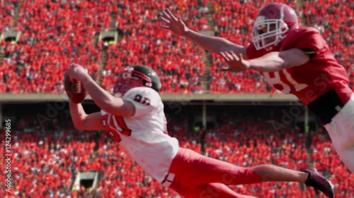 Football catch, slow motion, a football player catches a football in a stadium, 