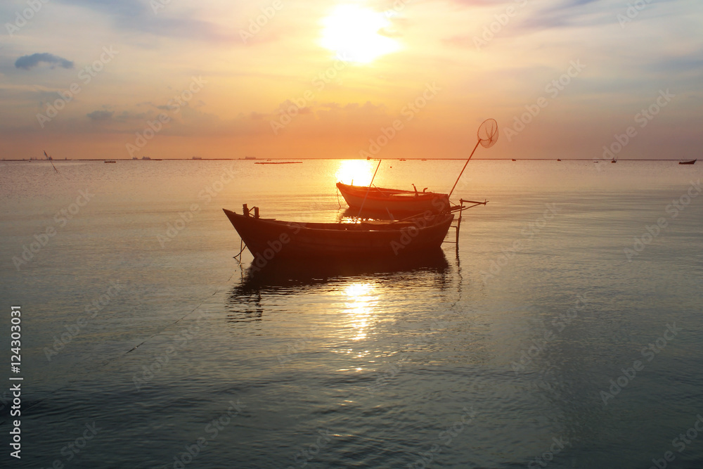 Silhouette natural background of small fishing boats moored beached on the beach during time the sunset and the beautiful natural of the colorful sky at BangPhra beach , Chonburi province in Thailand Silhouette natural background of small fishing boats moored beached on the beach during time the sunset and the beautiful natural of the colorful sky at BangPhra beach , Chonburi province in Thailand