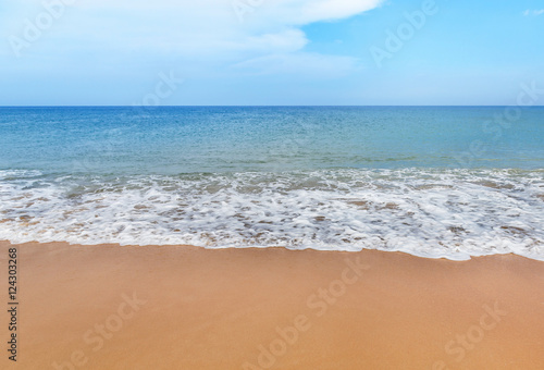 white soft wave on empty tropical beach and blue sea with blue sky and white cloud background
