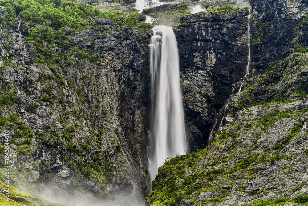 Fototapeta premium landscape of a small waterfall cascading in a pool of water