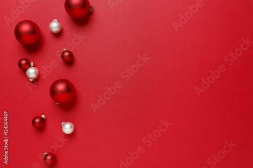 Christmas ornaments decorations background. Classic bright red and white glass baubles balls horizontal border. © ML Harris