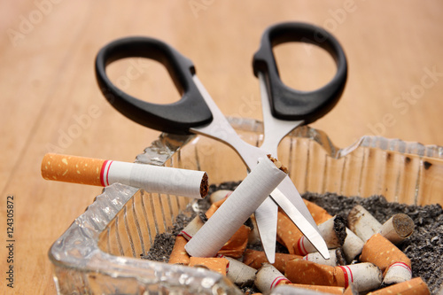 stop smoking / scissors cut a cigarette on ashtray