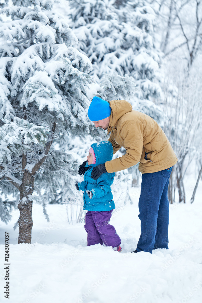 Father and daughter walk in deep snow. Father and daughter walk in deep snow.