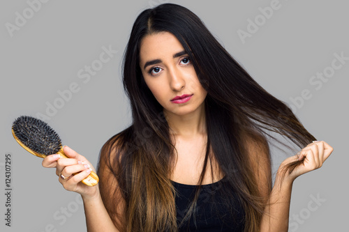 Canvas Print Woman having a bad hair day frustrated at dry tangled frizzy unmanageable damage
