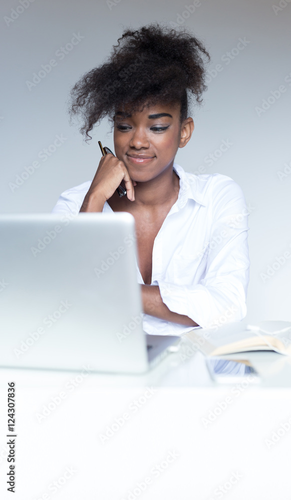Happy contented young African American woman with an afro hairst Happy contented young African American woman with an afro hairst