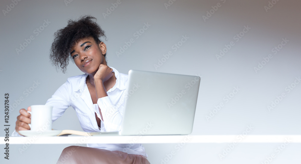 Pretty afro american businesswoman working at desk in her office Pretty afro american businesswoman working at desk in her office