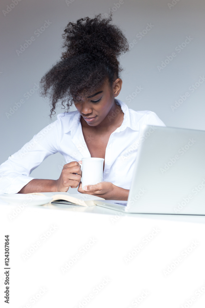 Happy contented young African American woman with an afro hairst Happy contented young African American woman with an afro hairst