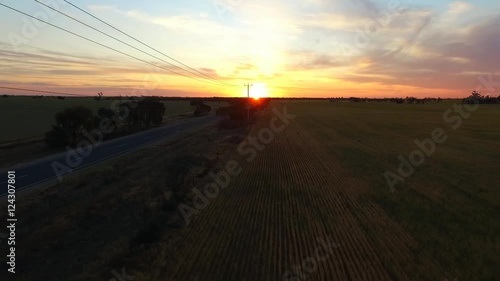 Aerial view of outback highway or open road on dusk (sunset) with truck traveling on rural country high speed freeway or motorway driving scenes on open road.  photo
