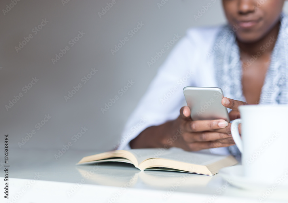 Casual businesswoman texting on phone in her office Casual businesswoman texting on phone in her office