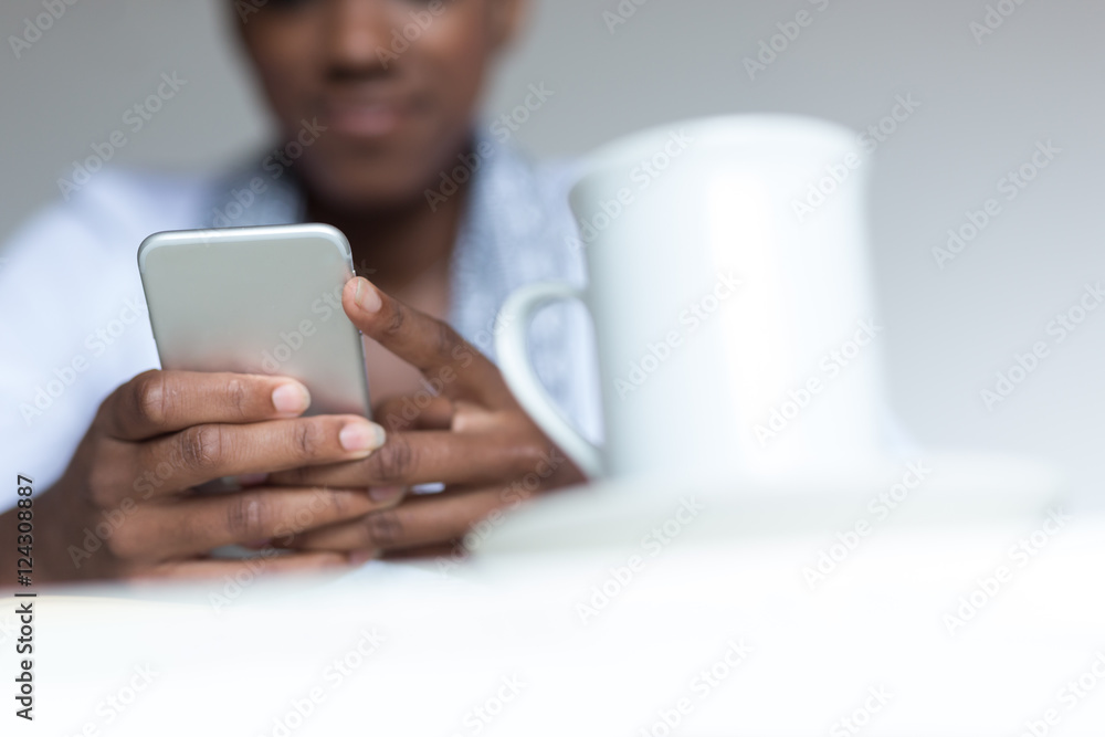 Casual businesswoman texting on phone in her office Casual businesswoman texting on phone in her office
