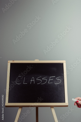 Classes written in white chalk on a black chalkboard
