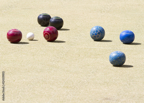 Bowls or lawn bowls is a sport played on outdoor lawn which is natural grass or artificial turf. The objective of the game is to roll biased balls to stop close to a smaller ball jack or kitty.